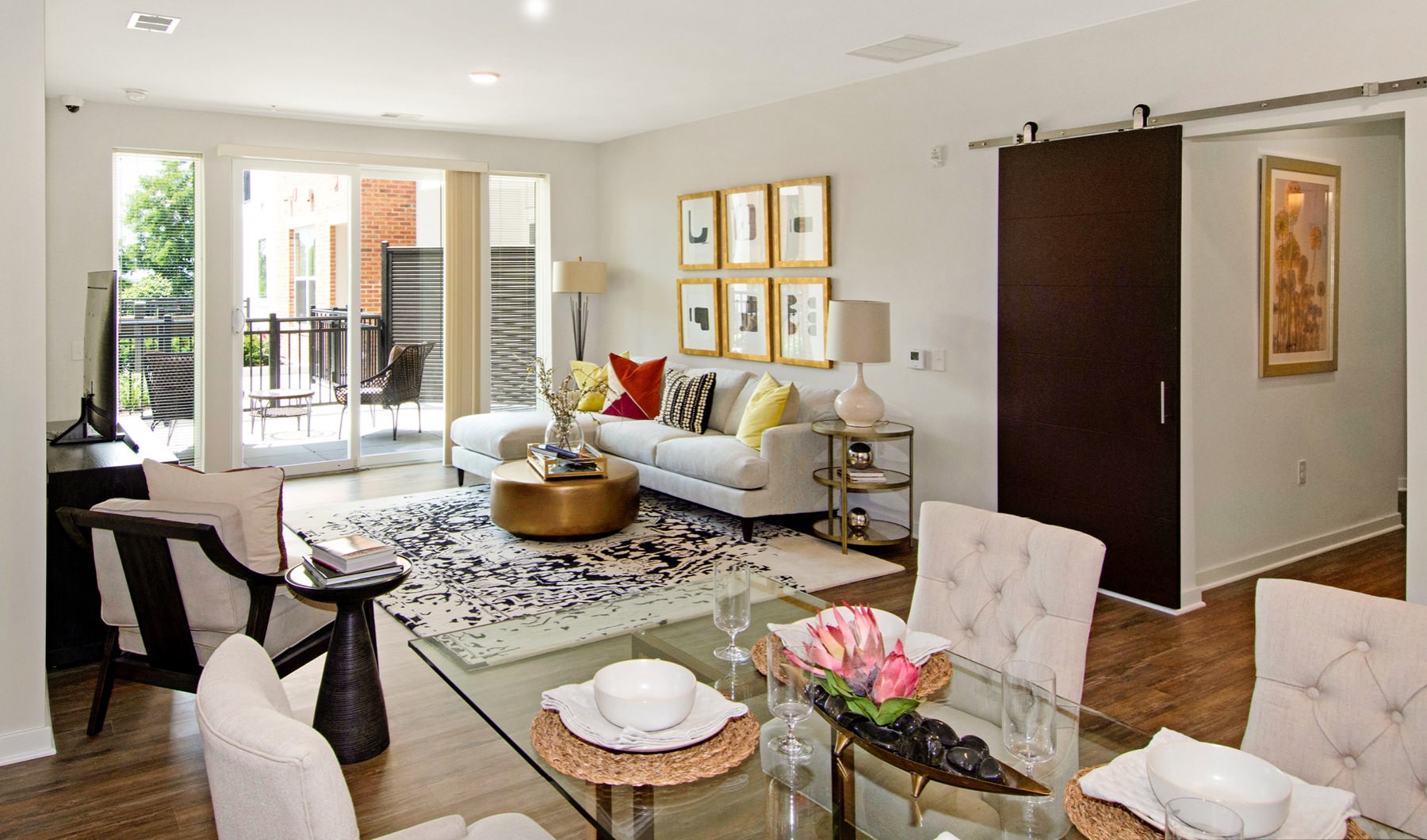 All Charm. All Access. open concept living room and dining area with access to private balcony